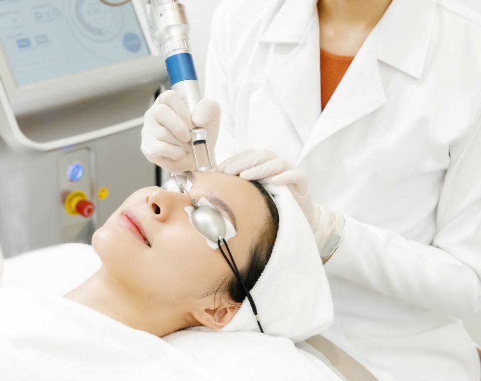 doctor performing aesthetic laser treatment